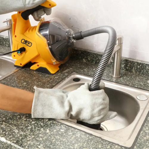 Cleaning clogged pipes with professional tools